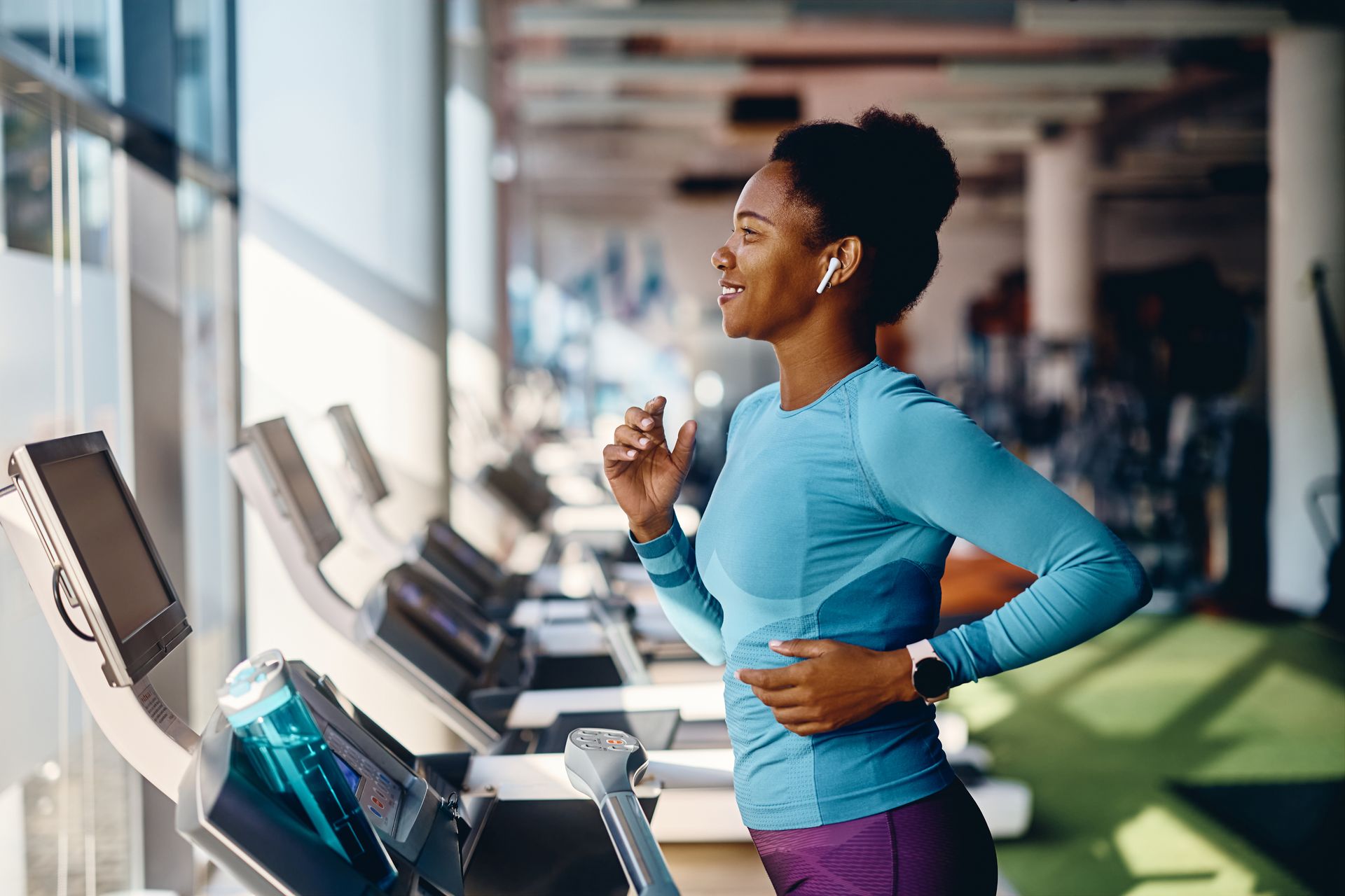 Resident working out in a bright, modern fitness facility